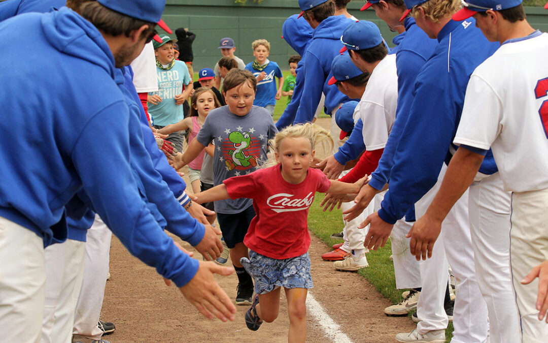 A young fan high-fives Crabs players after the game.